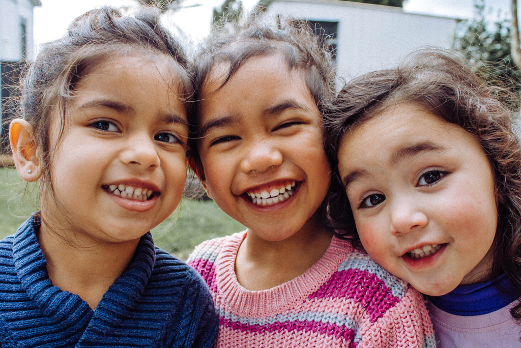 three kids smiling 